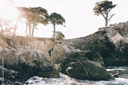 Man standing on rocks by sea