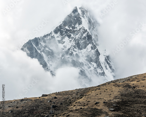 Himalayan peak in the clodly weather - Everest region, Nepal photo