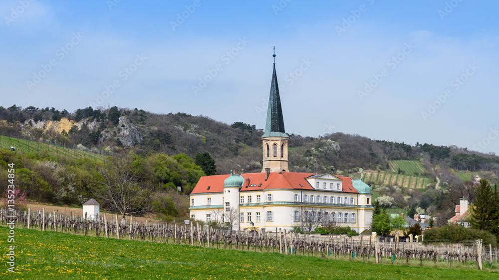 Teutonic Order Castle and spire of church St. Michael in springtime, panoramic view, Gumpoldskirchen near Vienna, Austria