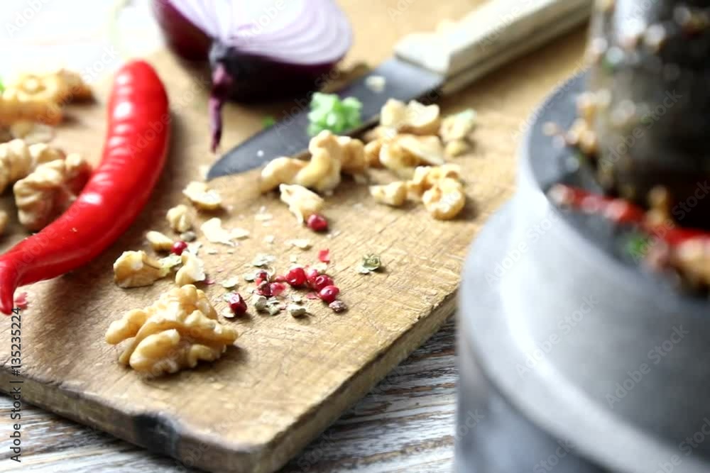 Various herbs and spices minced in granite mortar on wooden background. Various herbs and spices minced in granite mortar on wooden background.