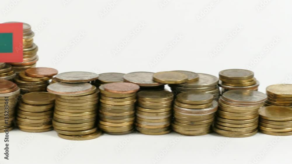 Maldives flag waving with stack of money coins Maldives flag waving with stack of money coins