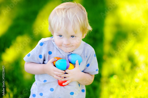 Canvas Print Little boy hunting for easter egg on Easter day