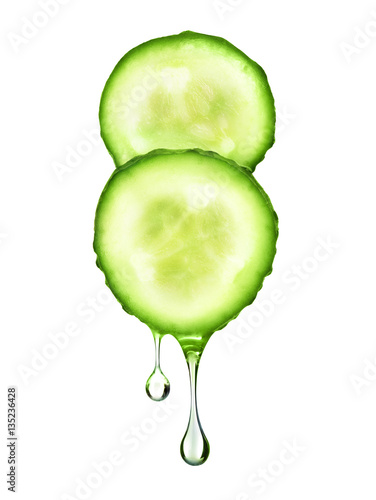 drop flowing from two fresh slices of cucumber on white backgrou