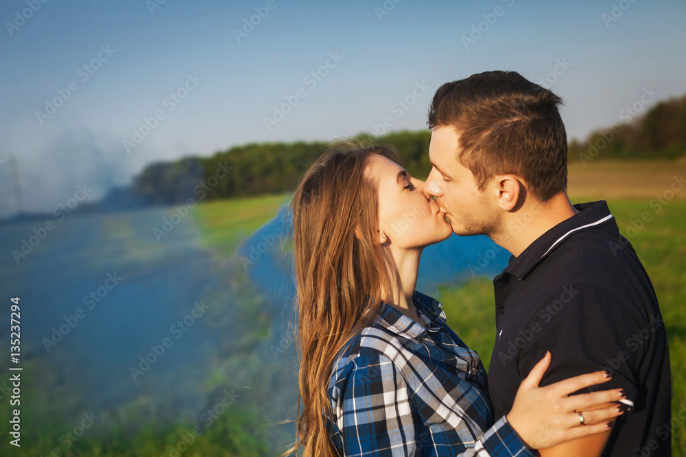 Young affectionate couple kissing tenderly Young affectionate couple kissing tenderly