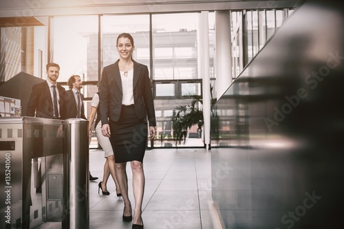 Confident businesswoman walking in office