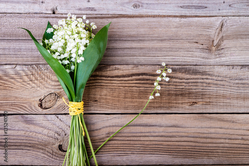 Lily of the valley bouquet  on wooden background.