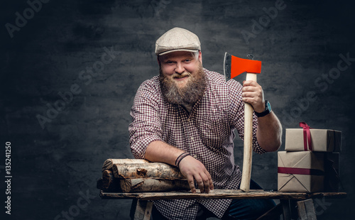 Canvas Print The fat bearded male holds an axe.