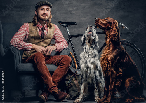 A man with Ireland setter dogs. photo