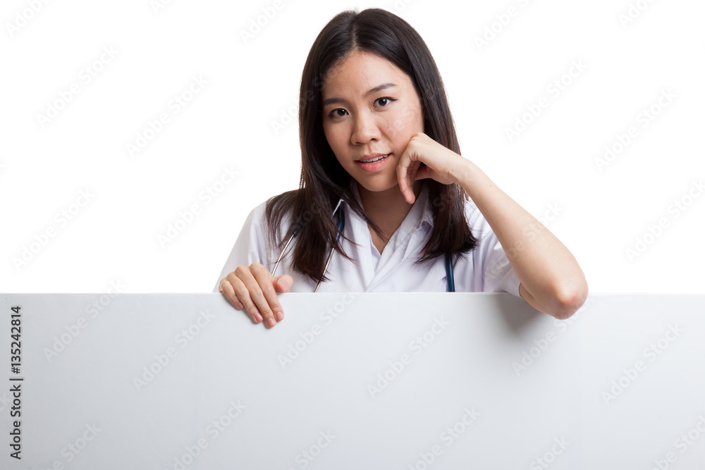 Young Asian female doctor standing behind blank white billboard. Young Asian female doctor standing behind blank white billboard.