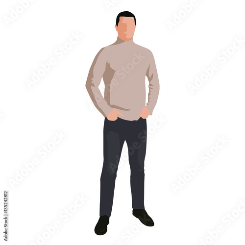 Man in light brown sweater and jeans standing with hands in pock