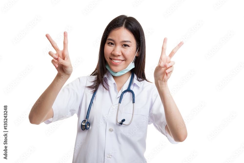 Young Asian female doctor show victory sign with both hands. Young Asian female doctor show victory sign with both hands.