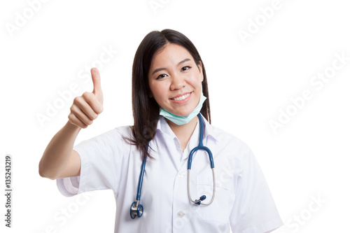 Young Asian female doctor show thumbs up.