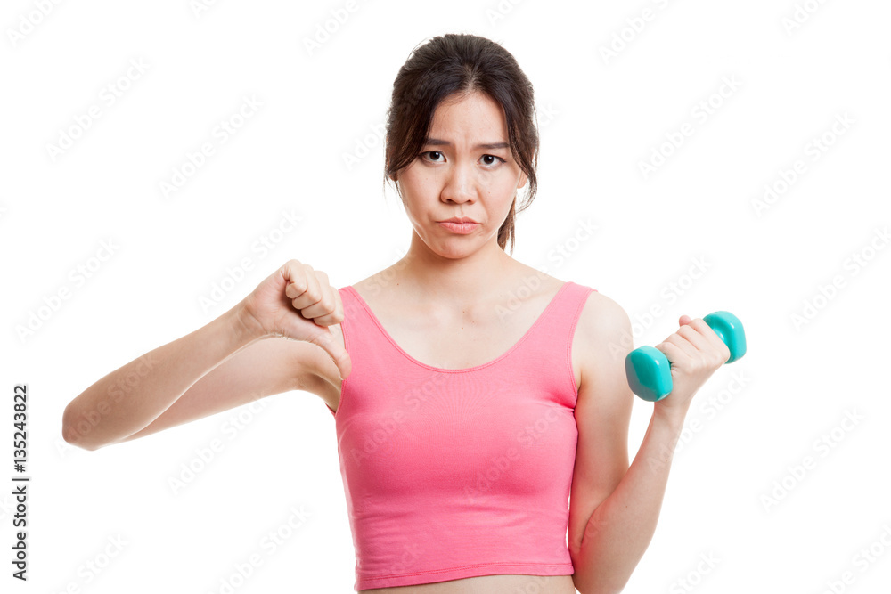 Beautiful Asian healthy girl thumbs down with dumbbell. Beautiful Asian healthy girl thumbs down with dumbbell.