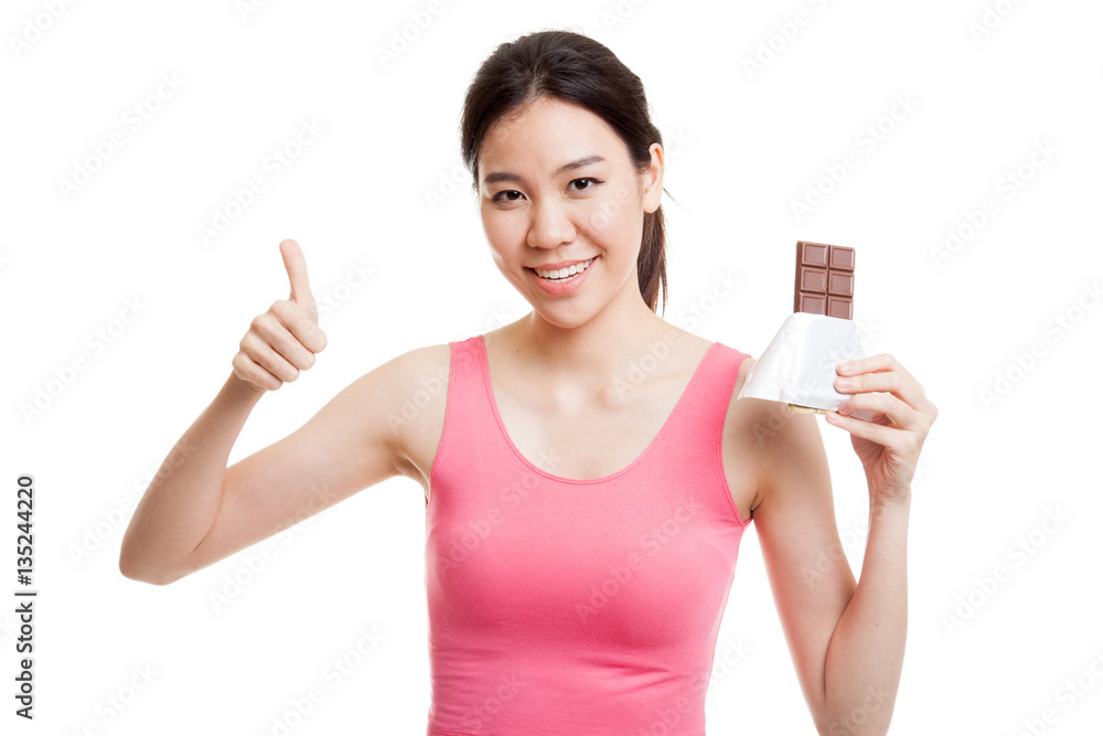 Beautiful healthy Asian girl thumbs up with chocolate. Beautiful healthy Asian girl thumbs up with chocolate.