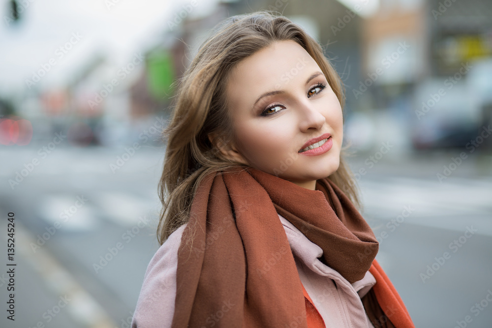 Beautiful woman outdoors. Cold outwear young girl looking at you camera