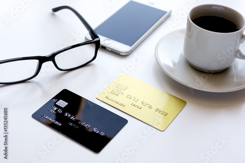 credit card, keyboard, smartphone and coffee cup on white background