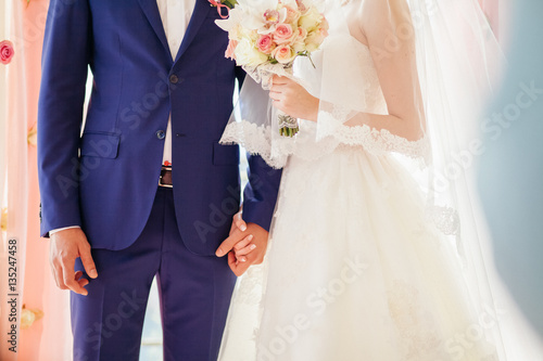 bride and groom holding hands together