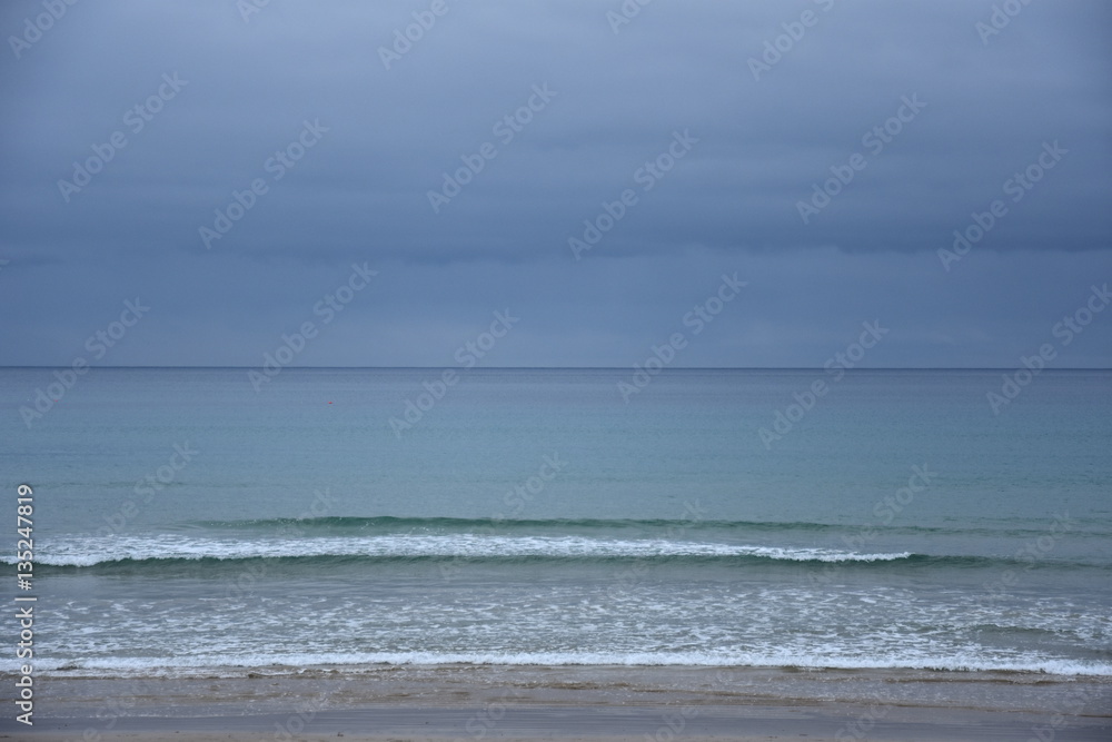 Gushing sea on a cloudy day. Horizontal view of dramatic overcast sky and sea. Fifty shades of blue. Gushing sea on a cloudy day. Horizontal view of dramatic overcast sky and sea. Fifty shades of blue.