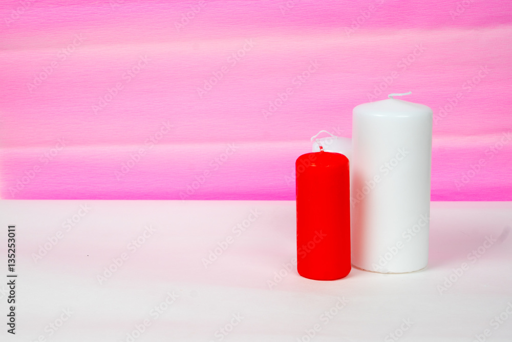 white and red candles with pink striped background white and red candles with pink striped background