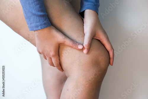 woman holding injured knee suffering pain injury pulled muscle