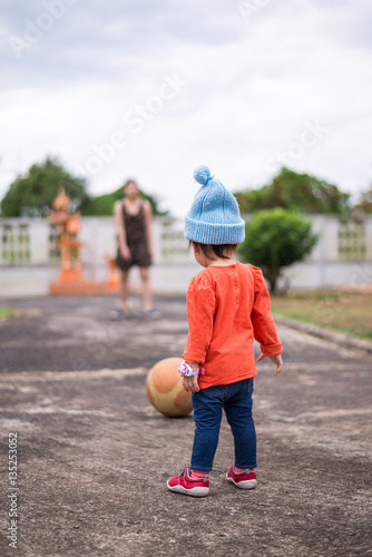 Baby girl taking a penalty kick in the playground