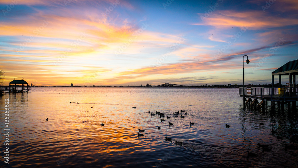Ducks on a lake at sunset.