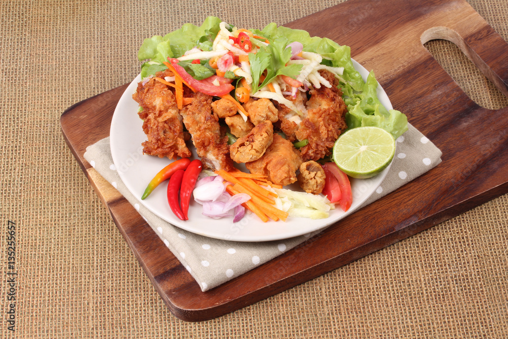 Spicy deep-fried chicken salad with roll green mango . Spicy deep-fried chicken salad with roll green mango .