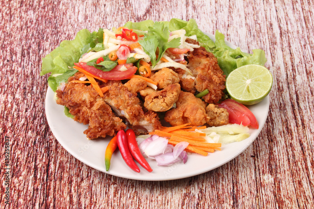 Spicy deep-fried chicken salad with roll green mango . Spicy deep-fried chicken salad with roll green mango .
