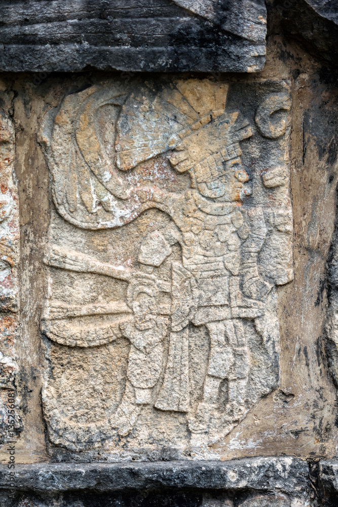 Ancient Mayan mural depicting a warrior on the Platform of the Skulls, a.k.a. Tzompantli in Chichen Itza, Yucatan, Mexico