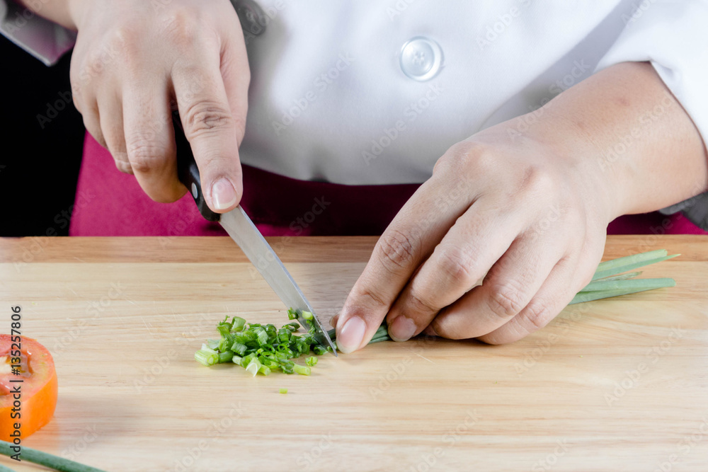 chef chopped green onions or spring onions on wooden board chef chopped green onions or spring onions on wooden board