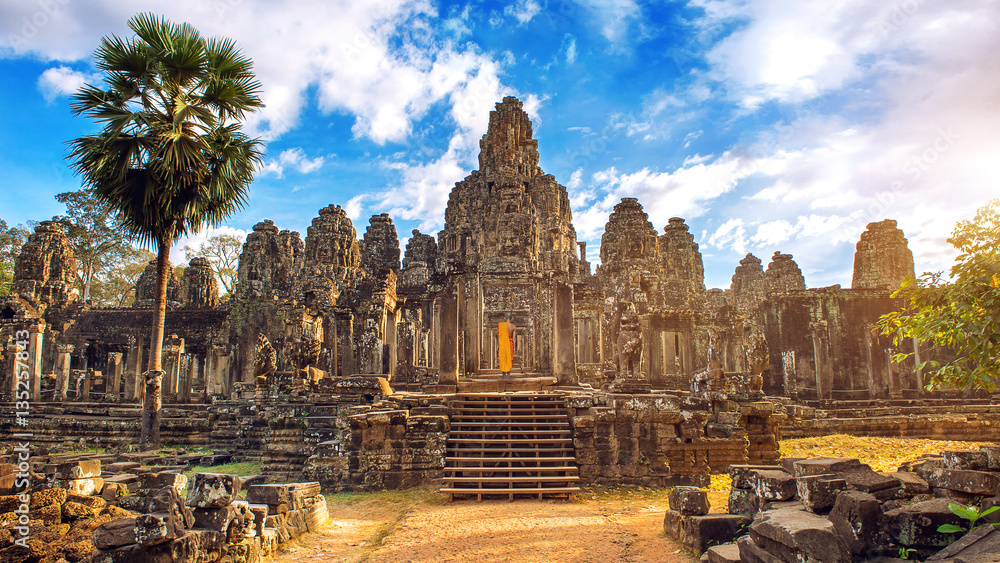 Obraz premium Starożytne kamienne twarze o zachodzie słońca świątyni Bayon, Angkor Wat, Siem Reap, Kambodża.