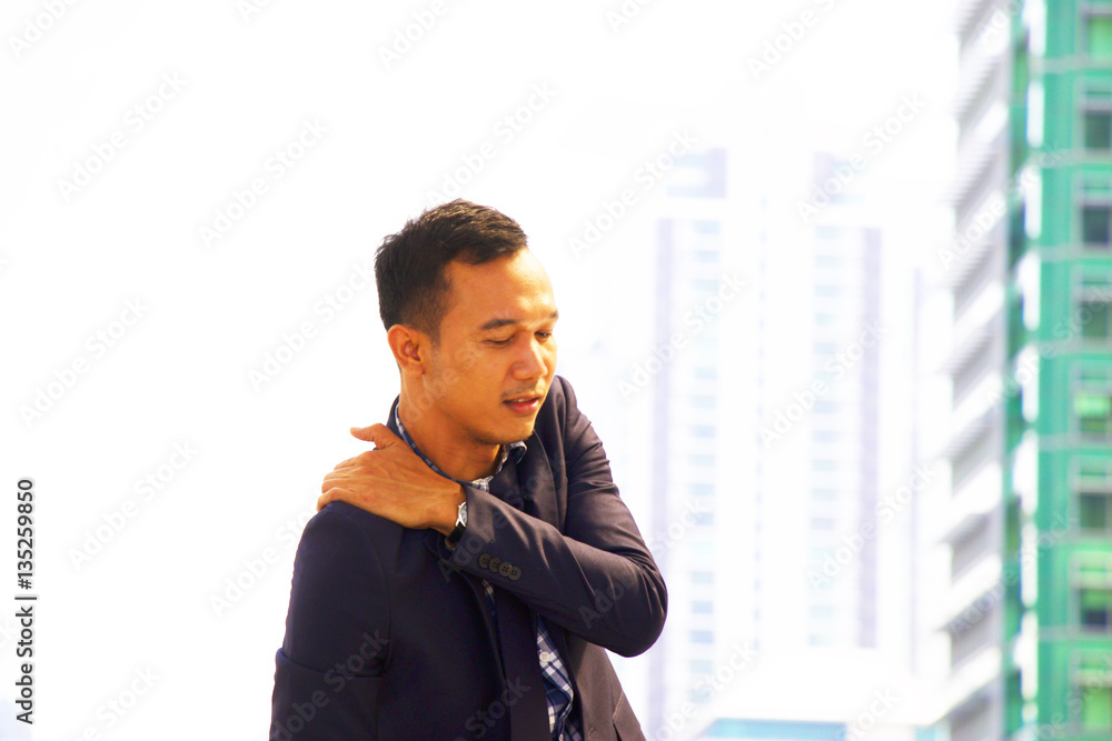 Working man is suffering from muscle pain at shoulder Working man is suffering from muscle pain at shoulder