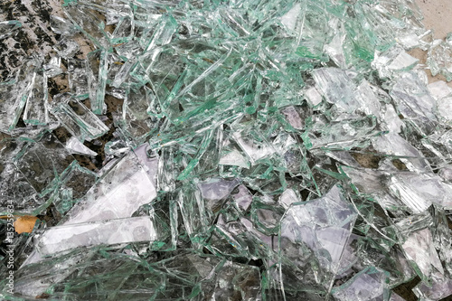 Heap of sharp shattered pieces broken glass on ground