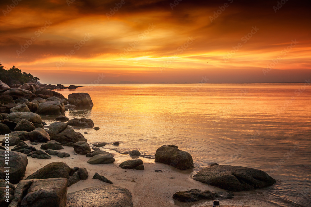 A beautiful rocky beach at sunset A beautiful rocky beach at sunset
