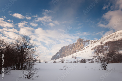 Rock Eklizi Burun in the snow under a blue sky with clouds © Aleksey Sagitov