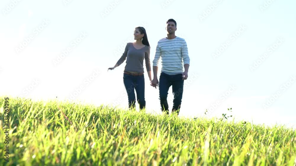 Couple walking in countryside on sunny fall day Couple walking in countryside on sunny fall day