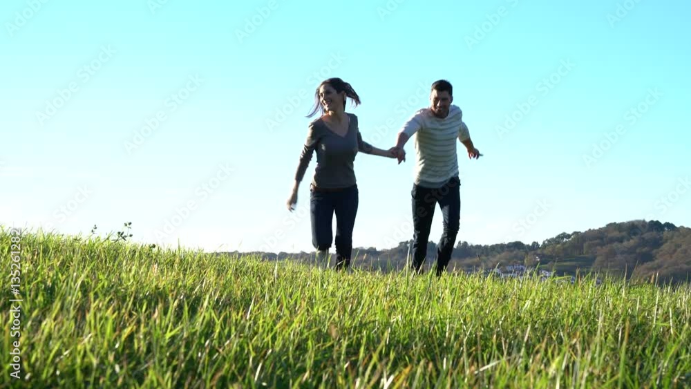Couple running in countryside on sunny fall day Couple running in countryside on sunny fall day