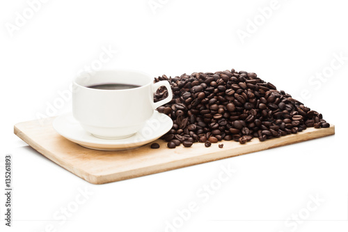 coffee mug on wooden plate with roasted coffee bean in background. Isolated on white background with clipping path.