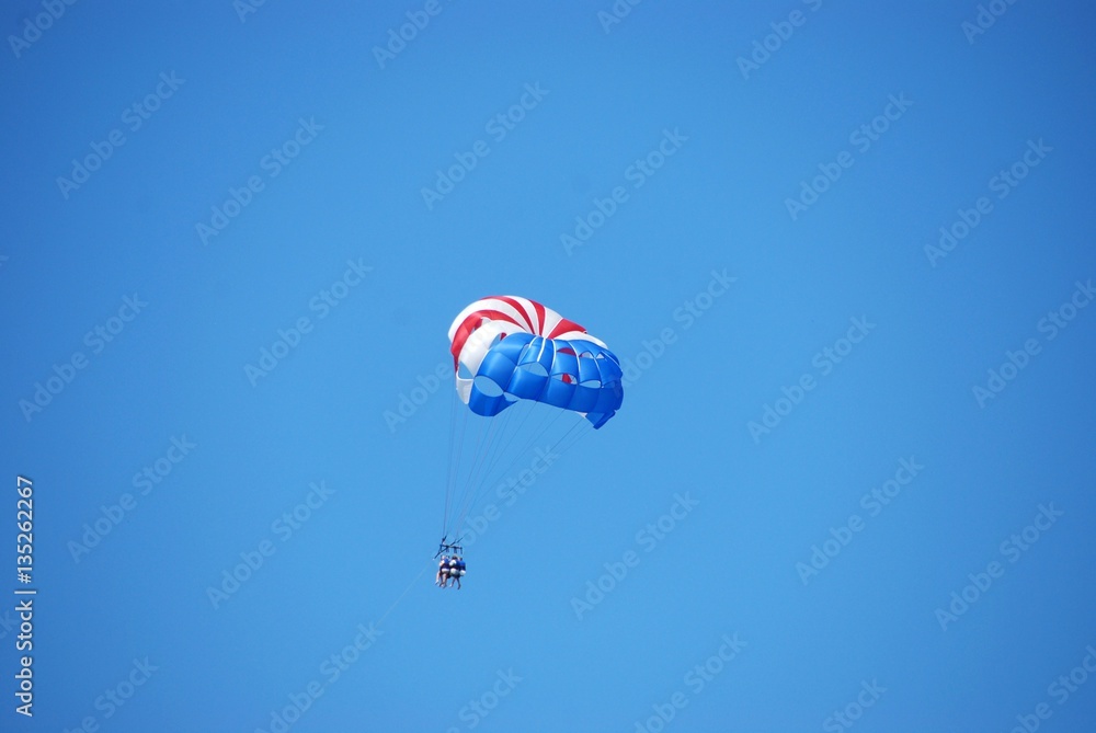 parasailing in flight with three passengers parasailing in flight with three passengers