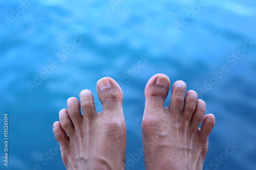 Foot and blue sea