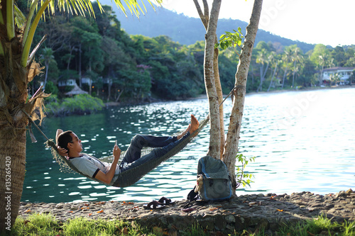 Man sleeping in a hammock at the beach
