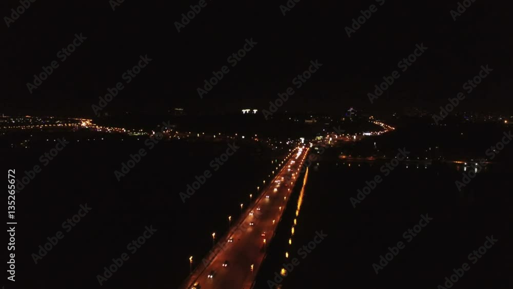 4K Aerial. Movement of cars on bridge through river. Night scene 4K Aerial. Movement of cars on bridge through river. Night scene