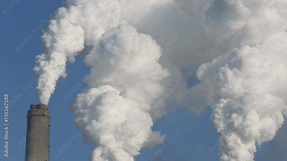 Giant clouds of smoke and vapor coming from power plant chimneys. Close up. Giant clouds of smoke and vapor coming from power plant chimneys. Close up.