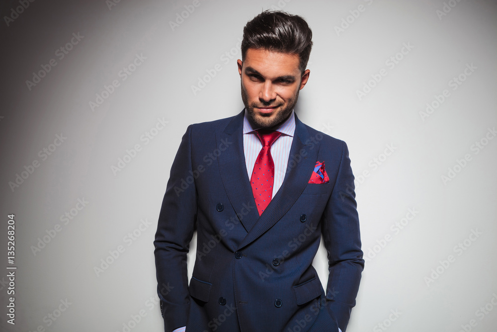 arrogant smiling business man with hands in pockets arrogant smiling business man with hands in pockets