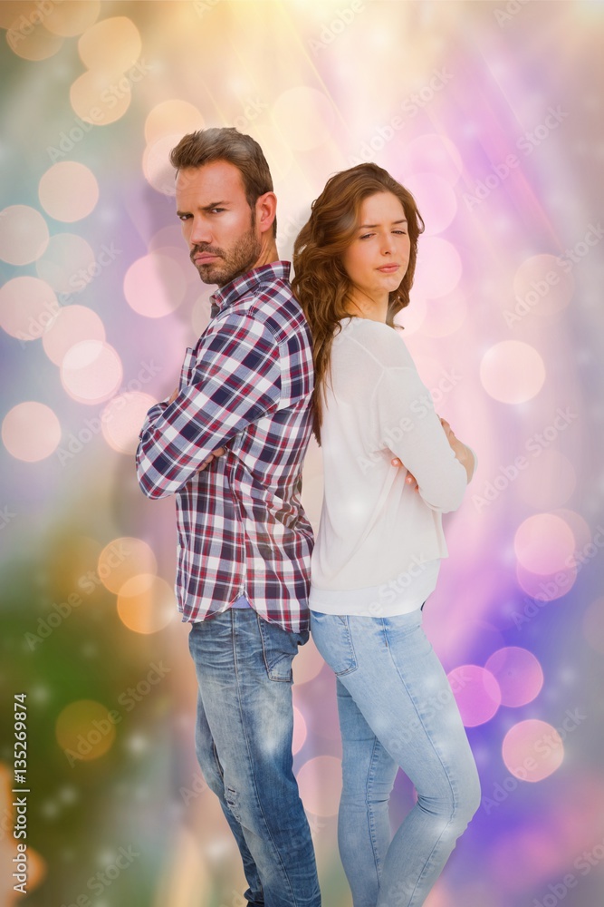 Composite image of depressed couple standing back to back Composite image of depressed couple standing back to back