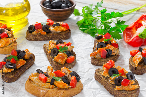 close-up of delicious bruschetta with pieces of mackerel fish