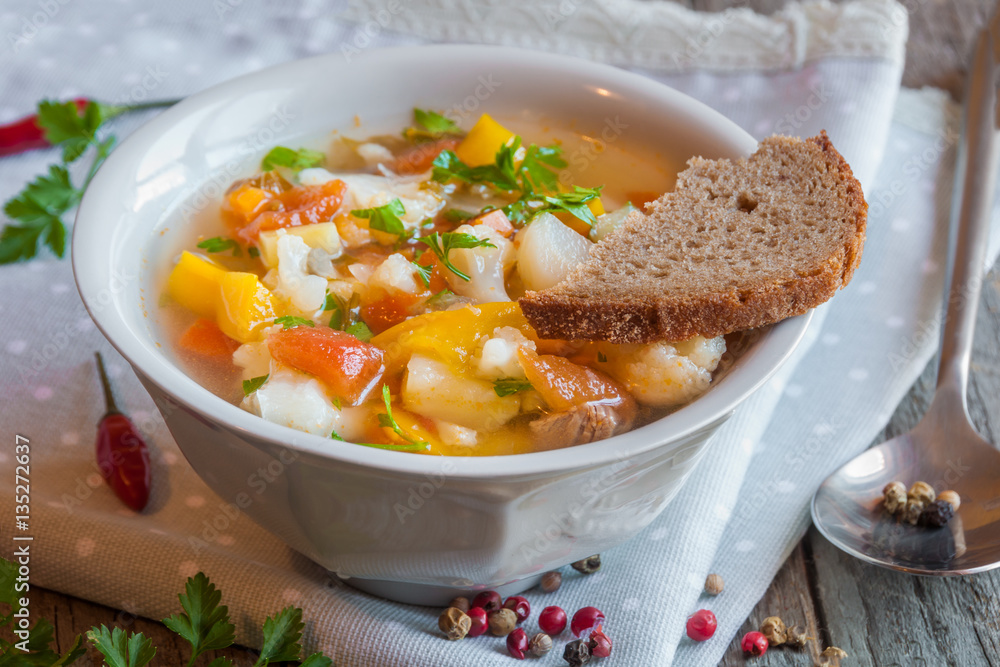 Vegetable soup with bread on wooden table Vegetable soup with bread on wooden table