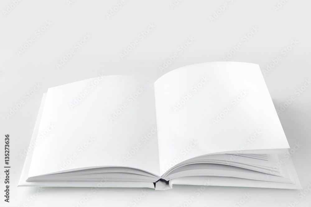 Open empty white book on a gray background. Open empty white book on a gray background.