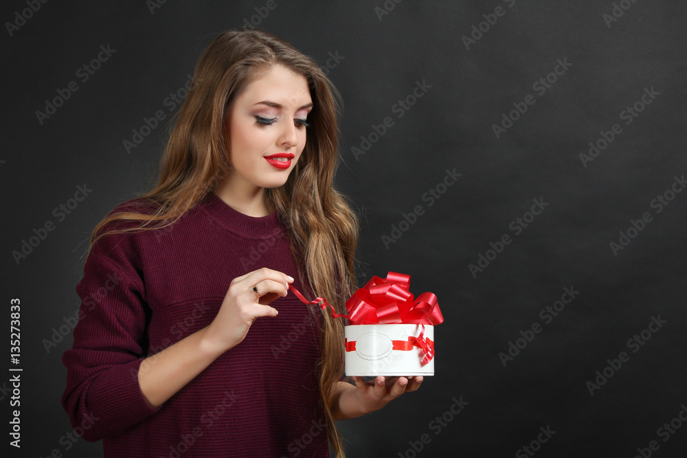 Beautiful girl holding a box of gift on Valentine's Day. Beautiful girl holding a box of gift on Valentine's Day.