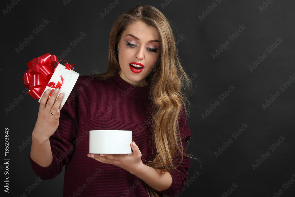 Beautiful girl holding a box of gift on Valentine's Day. Beautiful girl holding a box of gift on Valentine's Day.
